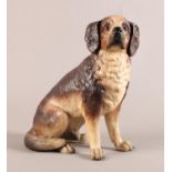 A good hollow terracotta model of a seated dog, realistically modelled and painted in creams and
