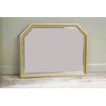 A reproduction gilt over mantel mirror of geometric arched form with bevelled plate within beaded