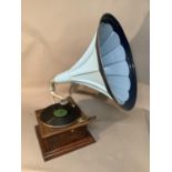 An oak gramophone with turquoise and blue painted horn and white metal arm, 74cm high max, horn