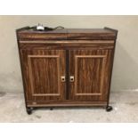 An Ekco hostess trolley with sliding top fitted with stainless steel fittings above cupboard