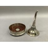 A silver bottle coaster with draught turned base and central silver button, 13cm diameter, by R.C.