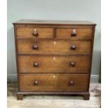 An early 19th century chest of two short over three long cockbeaded drawers, shield shaped bone