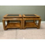 A pair of stained elm coffee tables in Chinese style, inset bevelled smoked glass tops, within broad