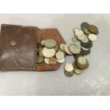 A small quantity of British coins contained in a leather wallet
