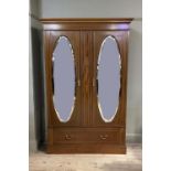 An Edwardian inlaid mahogany wardrobe, flared cornice with Greek key border, the frieze and doors