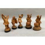 A set of five Chinese fruitwood carvings of children playing various instruments, each raised on a