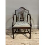 A Hepplewhite style mahogany elbow chair with camel back pierced waisted splat, drop in seat, on