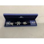 A Swarovski crystal RHS bracelet of pierced pendant link design with original box and papers