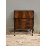 A reproduction mahogany bureau in George III style, figured flap, conventionally fitted interior