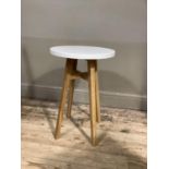 An oak framed occasional table with circular white top, 40cm diameter x 60cm high