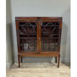 A Regency mahogany bookcase top, the pair of glazed doors applied with arched glazing bars, ovals