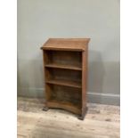 An oak open bookcase with lectern top with shaped apron, 56cm wide, 95cm high