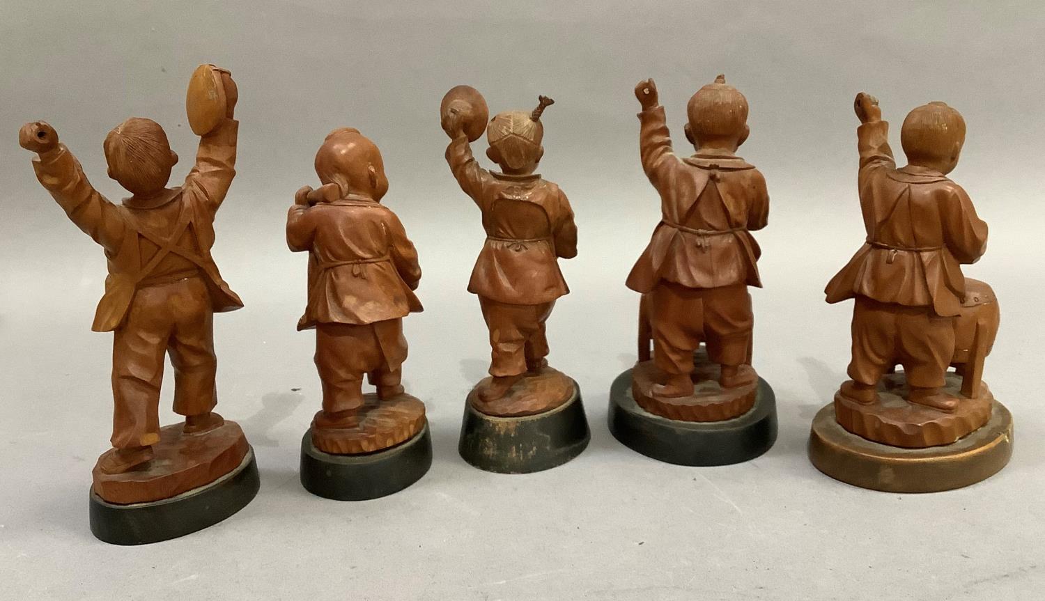 A set of five Chinese fruitwood carvings of children playing various instruments, each raised on a - Image 3 of 3