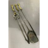 A set of three Victorian style fire irons with cast brass foliate terminals, comprising poker,