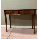 A reproduction mahogany two drawer serving table of serpentine outline, kingwood boxwood and ebony