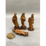 Four Chinese fruit wood carvings of deities, eached raised on a plinth, heights ranging from 15.