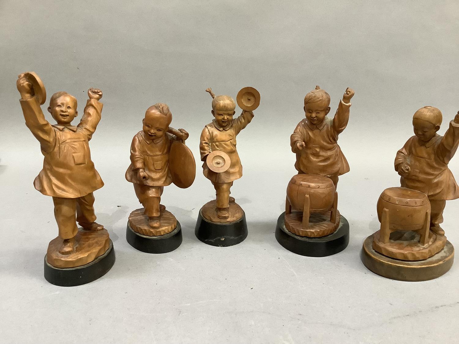 A set of five Chinese fruitwood carvings of children playing various instruments, each raised on a - Image 2 of 3