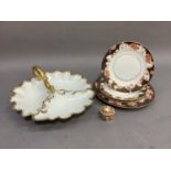 A continental porcelain, leaf moulded hors d'oeuvre dish with scroll handle, detailed in gilt;