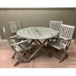 A circular teak slatted garden table, 120cm diameter, together with a set of four Westminster teak