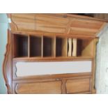 A reproduction cherry wood veneered triple wardrobe with arched moulded cornice above central