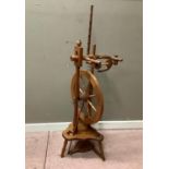 A reproduction cedar spinning wheel, 124cm high overall approximately