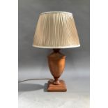 A laminate wooden table lamp with pleated brown shade