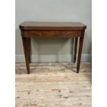 A 19th century mahogany tea table with rectangular top with rounded corners, moulded lip above