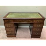 A reproduction mahogany twin pedestal desk in George III style, the rectangular top inset with green