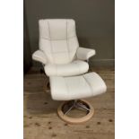 A Norwegian Stressless armchair and stool upholstered in cream leather, beech and brushed steel