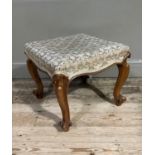 A Victorian walnut footstool on moulded cabriole legs with knurled toes, stuffed over top, 47cm