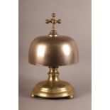 An unusual and large bronze cast iron and brass table bell with brass cruciform post and ball