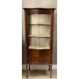 An Edward VII inlaid mahogany serpentine fronted display cabinet, flared cornice, shallow frieze,