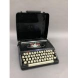 A vintage Brother Deluxe 220 portable typewriter in carrying case