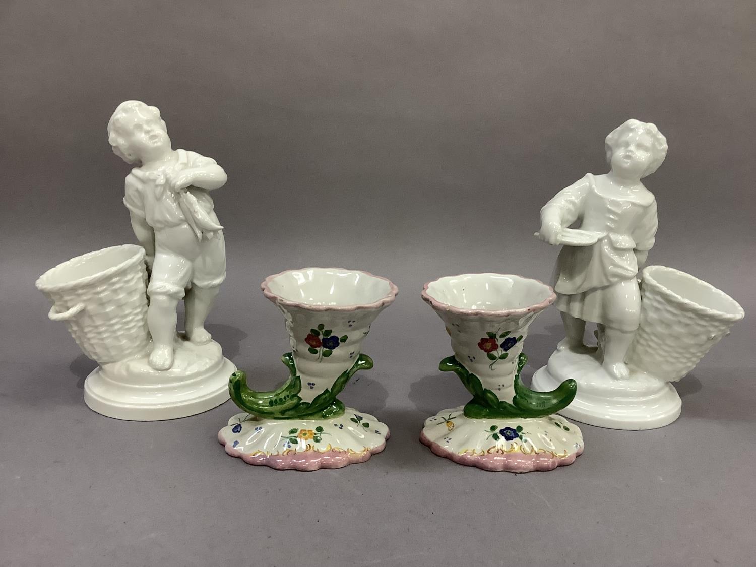 A pair of continental porcelain figures, fisherboys, each standing beside an open basket, 18cm high; - Image 3 of 3