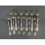 A set of twelve continental silver coloured metal forks with hatched shell scroll terminals, all