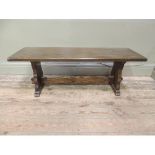 A reproduction oak refectory style coffee table, rectangular top, trestle ends and stretcher,