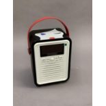 A Lulu Guinness stereo radio with carrying handle, in black, white and red