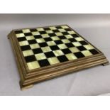 An onyx and ebony style chess board in wooden frame