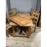 A reproduction oak refectory table with cleated end on chamfered square legs joined by stretchers