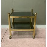 A brass framed two tier occasional table, cylindrical posts with ball finials, smoked glass shelves,