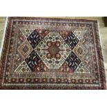 A machine woven rug in caucasian style worked with geometric medallions on a ground filled with