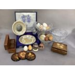 A musical jewellery box, ornamental eggs in onyx, ceramic and treen, treen box containing a set of