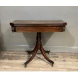 A Regency brass inlaid mahogany card table, the frieze with pair of inlaid rectangles, re-entrant