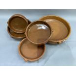 Five glazed terracotta cooking pots, circular outline with lug handles and of shallow depth,