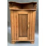 A pine corner cabinet with shelf above a single door, 66cm deep x 150cm high x 92cm wide