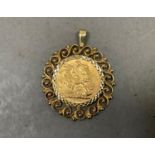 A Victorian 1900 sovereign collet set as a pendant in 9ct gold within a pierced and beaded surround,