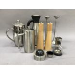 A pair of stainless steel candle holders, a polished steel cafetiere and milk jug, an insulated