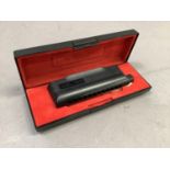 A Hohner CX12 Harmonica, in black plastic casing and original box