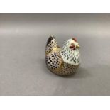 A Royal Crown Derby hen paperweight, gold button, 9.5cm wide, 7.5cm high