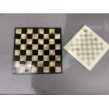 An onyx and black chessboard together with a composition chessboard